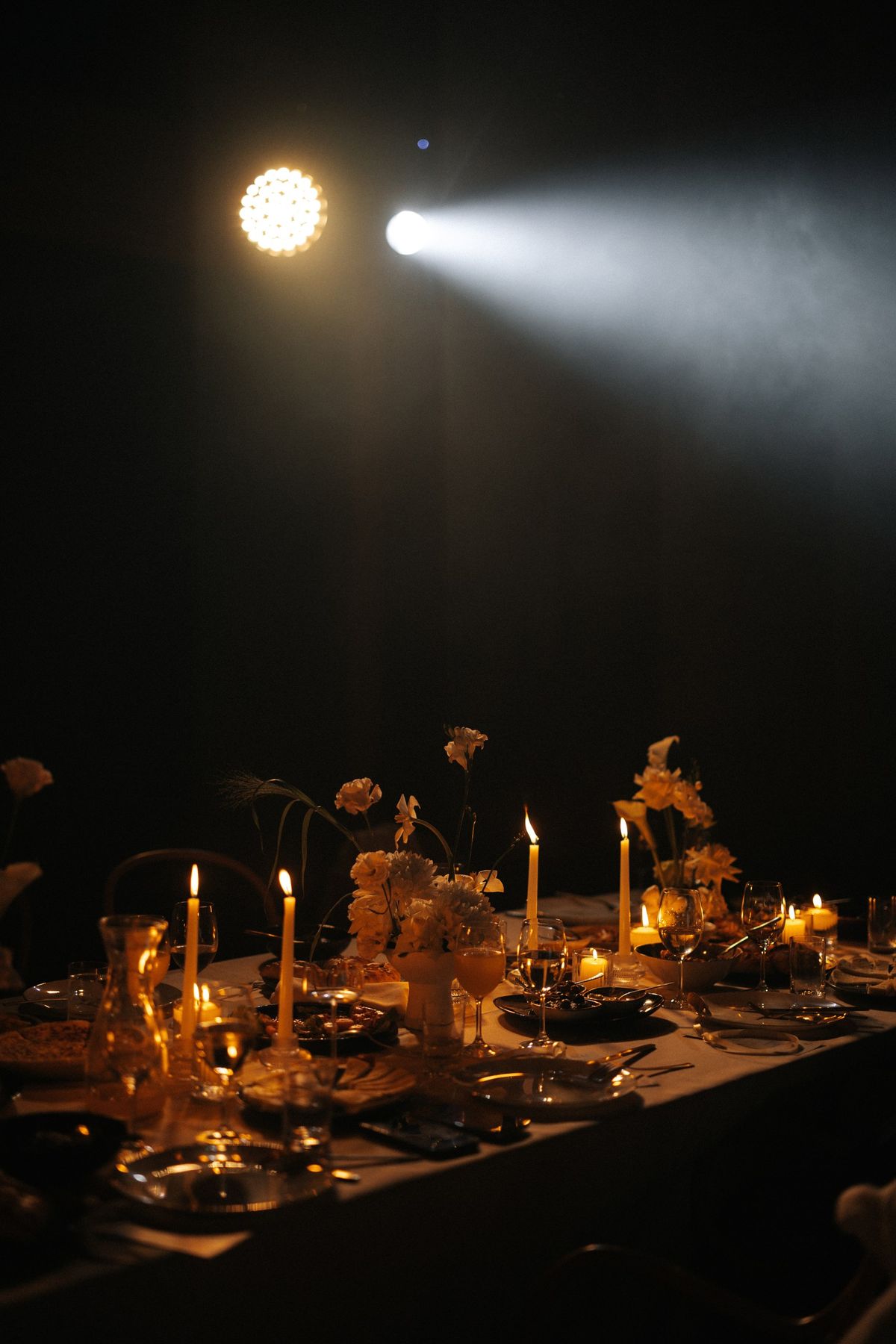 Candlelit table with warm floral arrangements