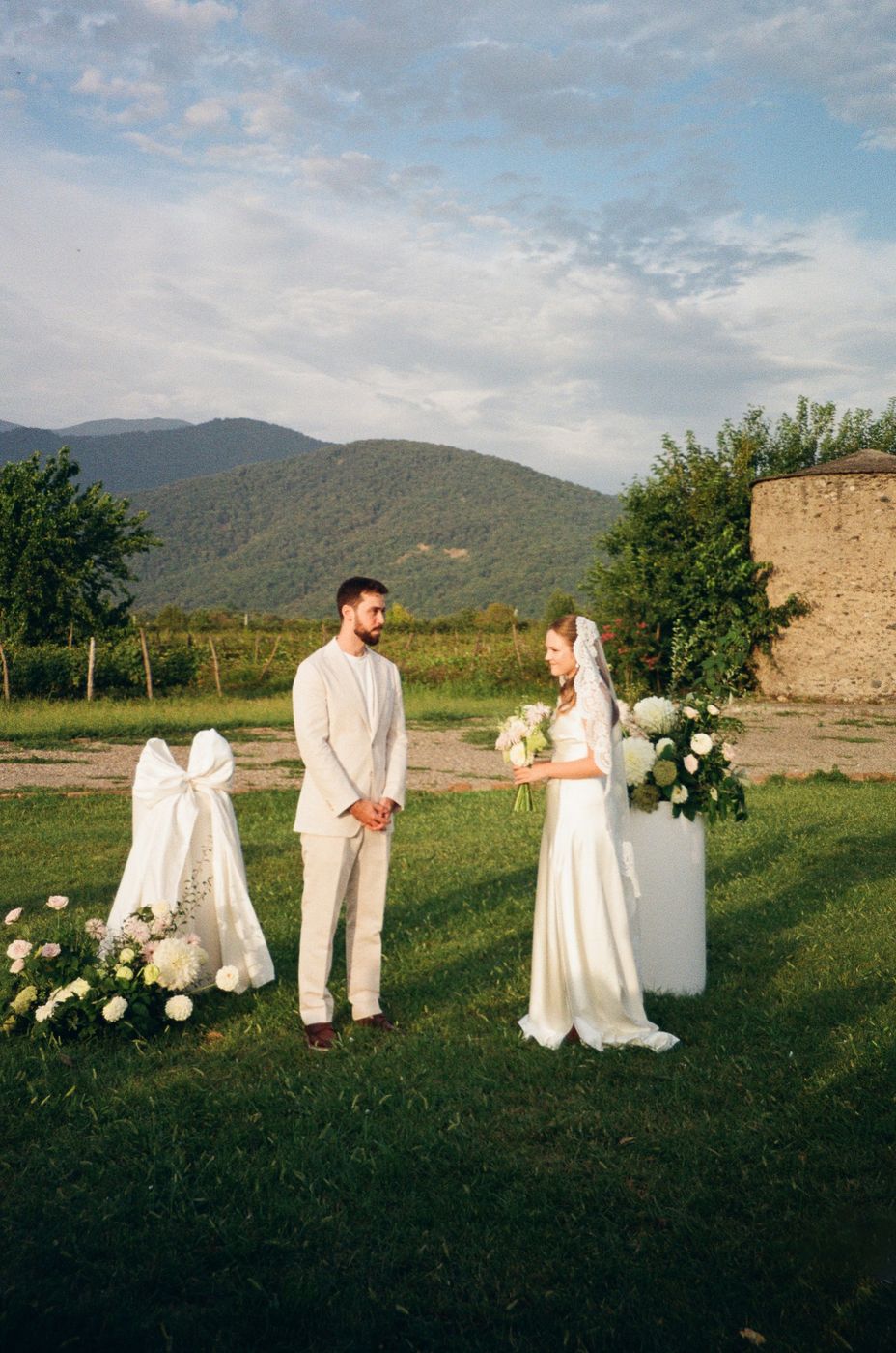 Newlyweds in the mountains beside a floral installation